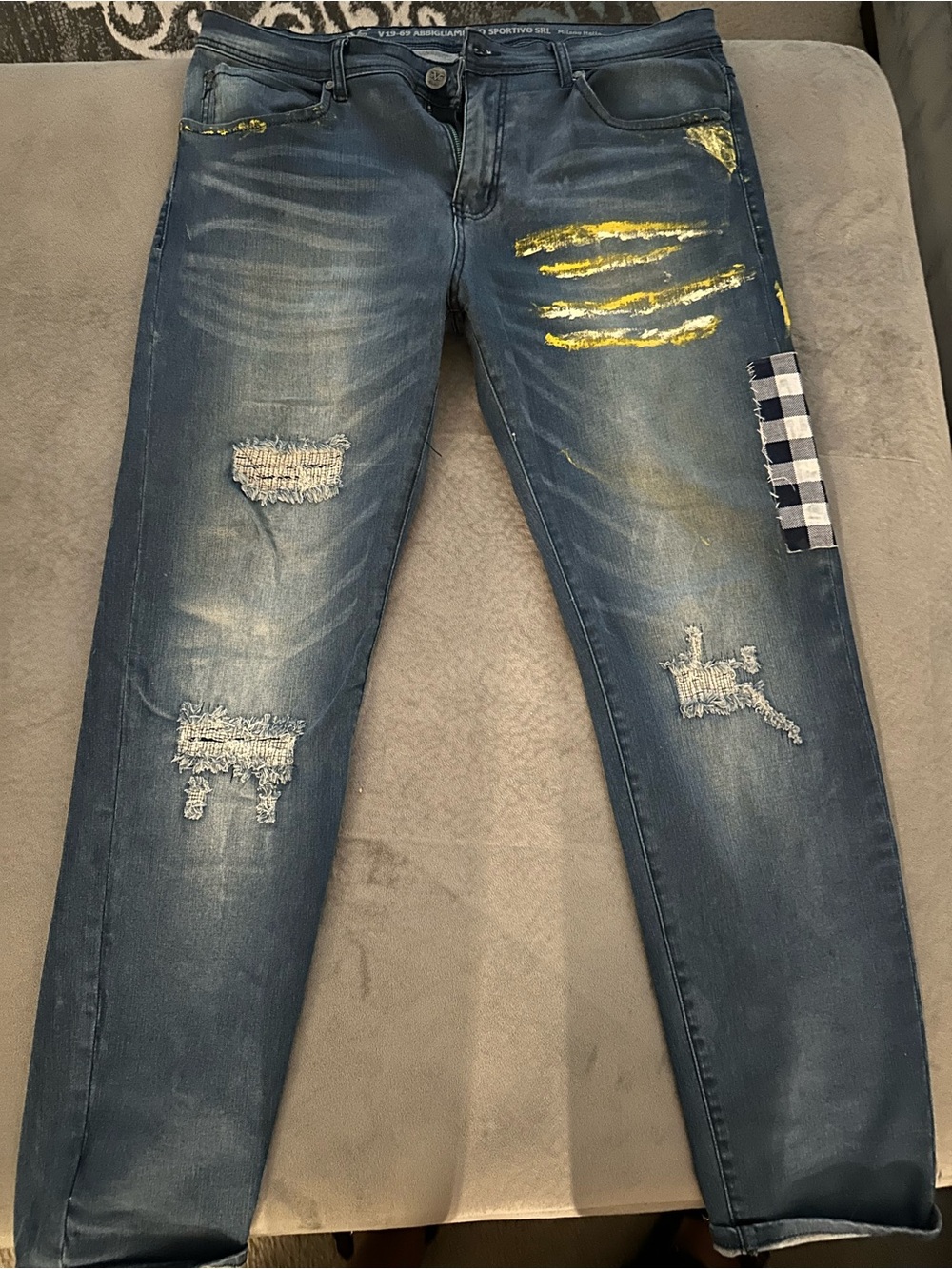 Men's Distressed Blue Jeans with Yellow Paint Accent